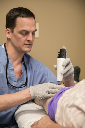 Physiatrist Jeremy Gallant, MD, of Methodist Physicians Clinic HealthWest Physiatry, gives an iovera treatment to a patient